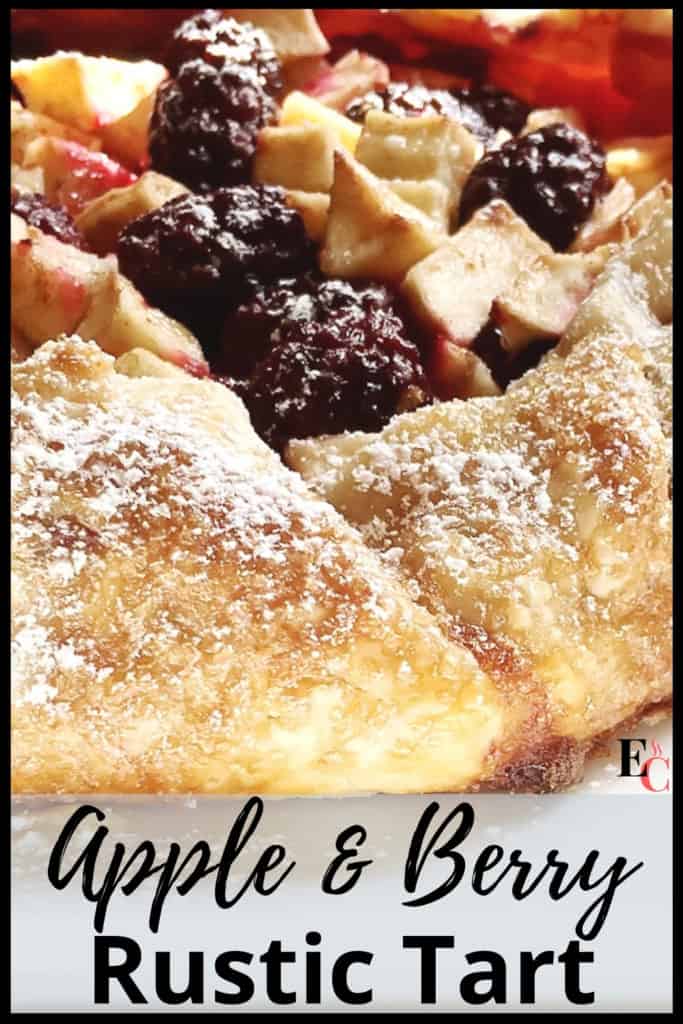 Close-up view of a rustic tart of apples and blackberries. The words Apple & Berry Rustic Tart are displayed at the bottom of the image. Pinterest Pin with black border.