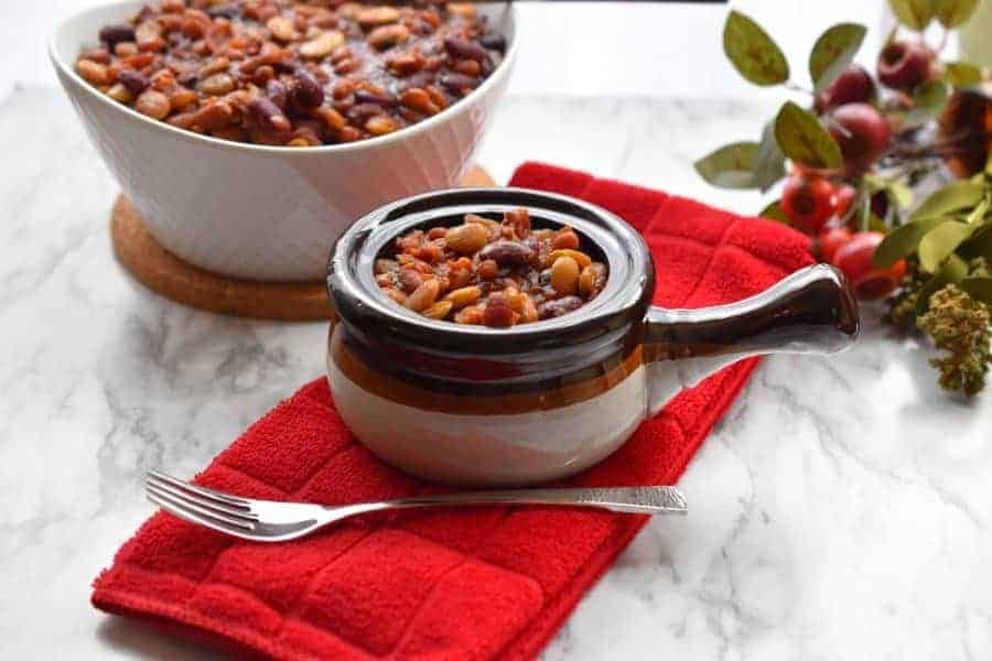 Baked Beans Supreme in a Handled Bowl with a Red Towel