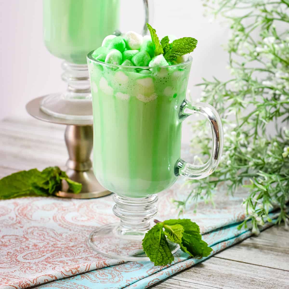 Light Green Hot Chocolate with Mini Marshmallows and Crème de Menthe Drizzle.