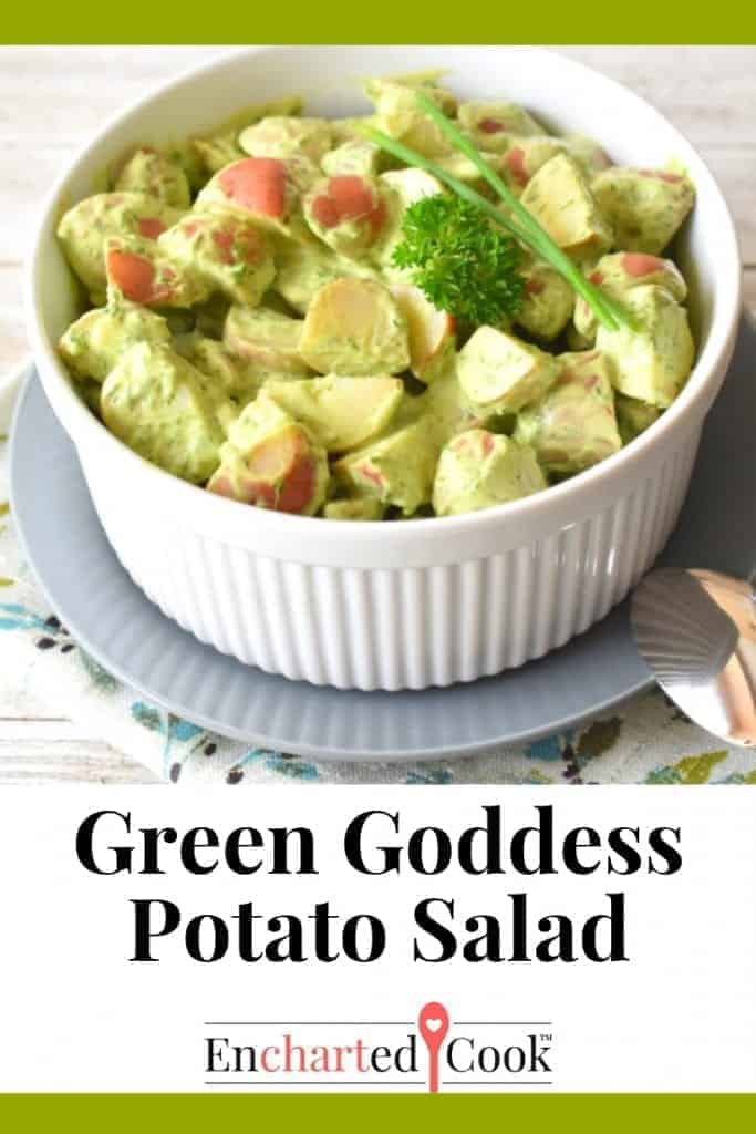 Large white souffle dish contains potato salad dressed in pale green salad dressing. The words "Green Goddesss Potato Salad" span the bottom of the image. Pinterest Pin 1.