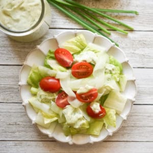 classic lettuce, tomato, and cucumber salad with Green Goddess Salad Dressing on a small plate