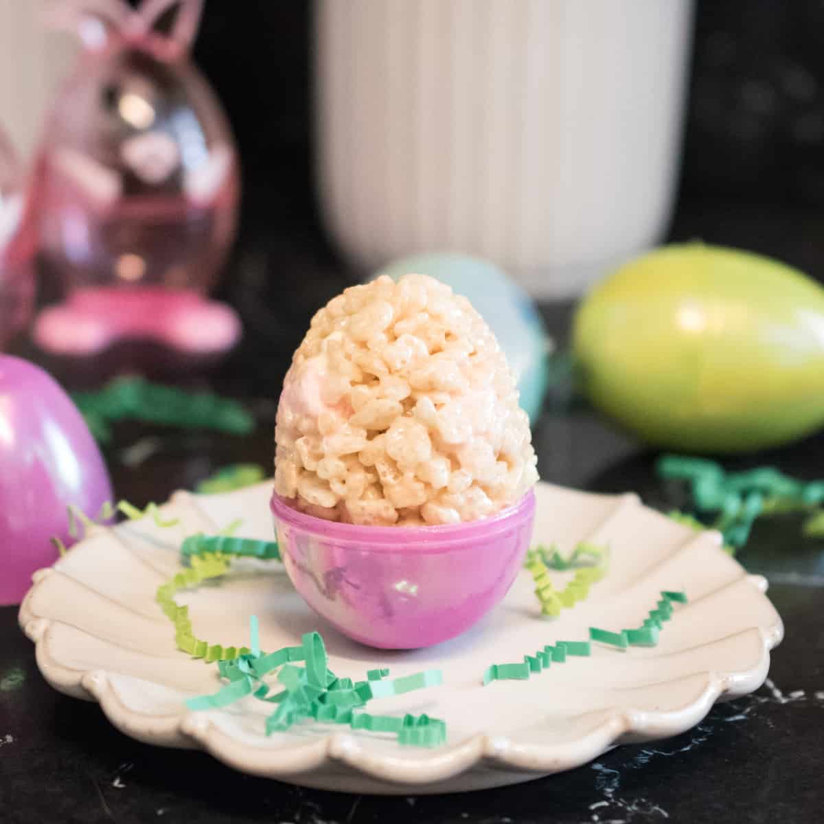 A marshmallow treat is molded into pink plastic egg.