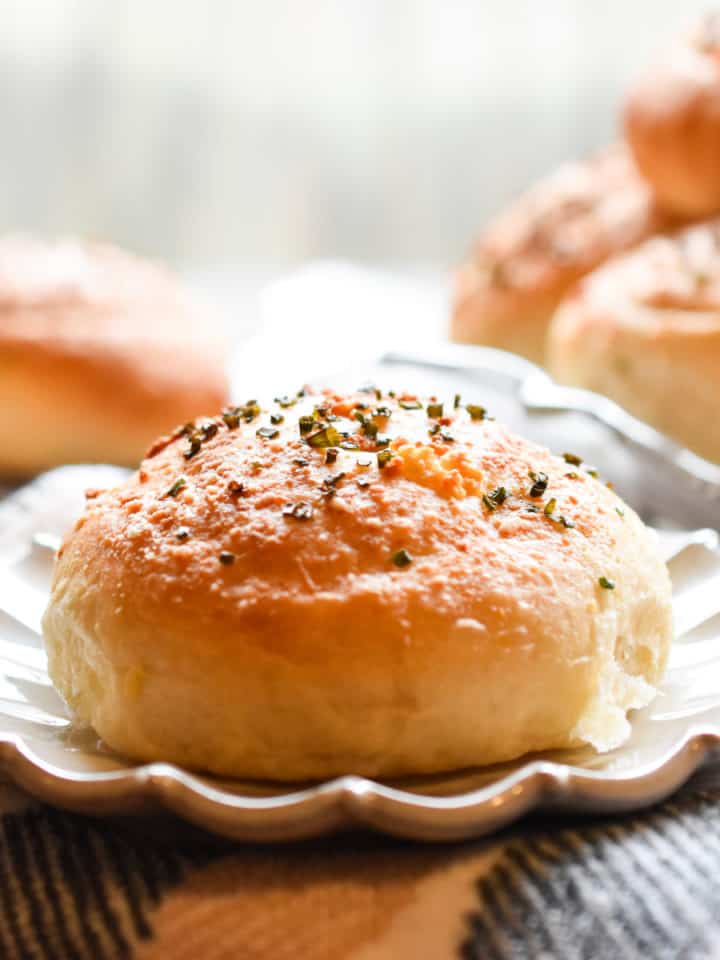 A single hamburger bun is on a fluted plate.