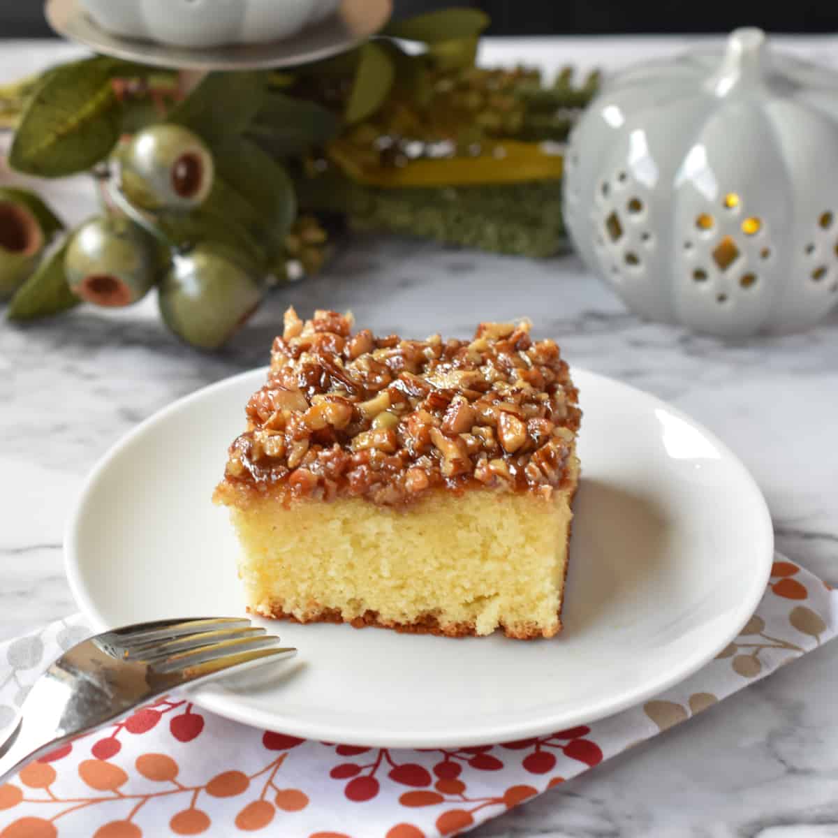 A slice of buttery rich cake topped with a broiled caramel and nut topping.