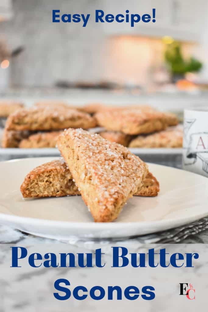 Two scones with a sugar topping are on a white plate. More scones are in the background and the words "Peanut Butter Scones" and "Easy Recipe!" are in navy blue lettering. Pinterest Pin-4.