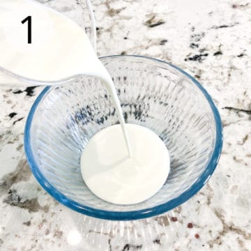 Heavy cream is being poured into a small blue-tinted clear glass bowl.