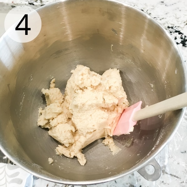 Sugar cookie dough comes together after the addition of flour.