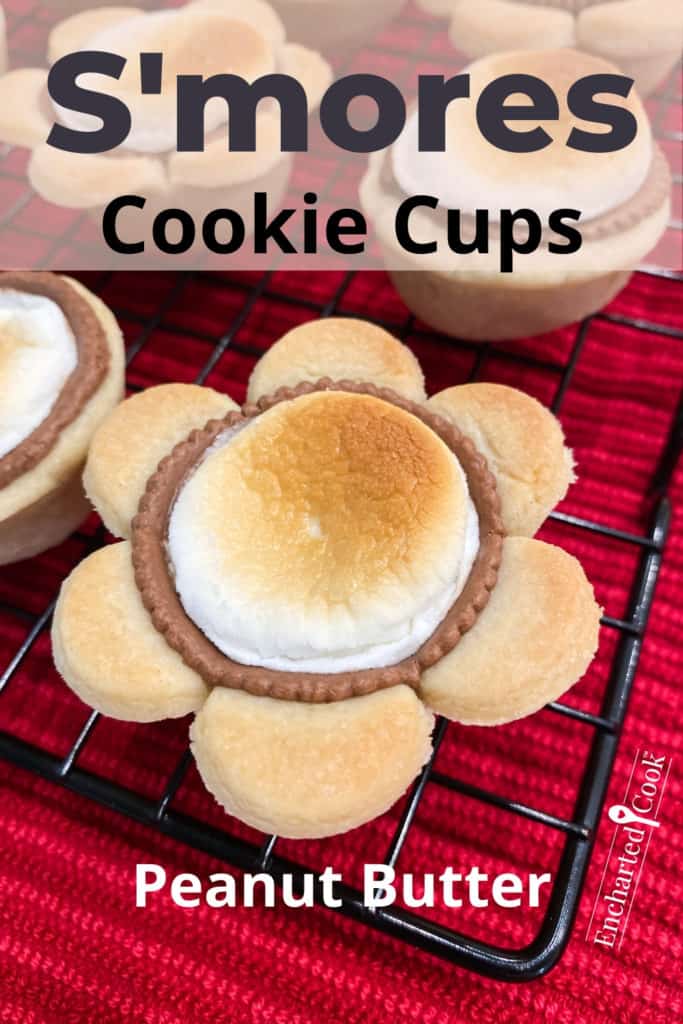 Adorable flower sugar cookie cup filled with gooey chocolate, peanut butter, and a toasted marshmallow sitting on a black wire rack. Pinterest Pin 8
