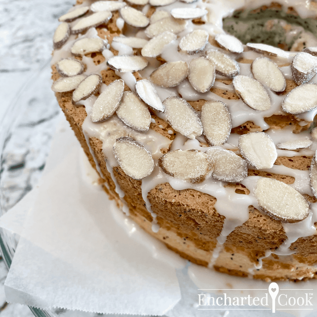 Drizzle the cake with the glaze and sprinkle the almonds over the top of the cake.