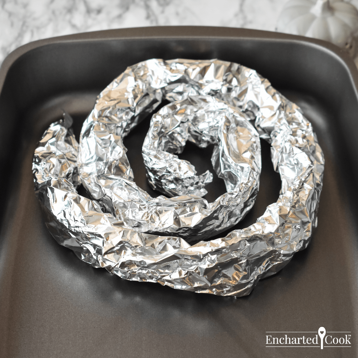 A simple roasting rack is made from coiled aluminum foil and placed in the roasting pan.