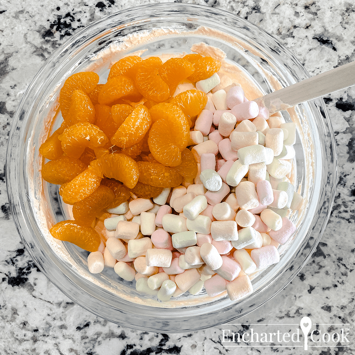 Mandarin oranges and pastel mini marshmallows are added to the yogurt mixture.