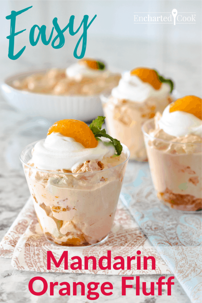 Portrait image of orange fluff in small cups and a bowl. Each serving is garnished with whipped topping, a mandarin orange, and a sprig of mint. Pinterest PIN #10