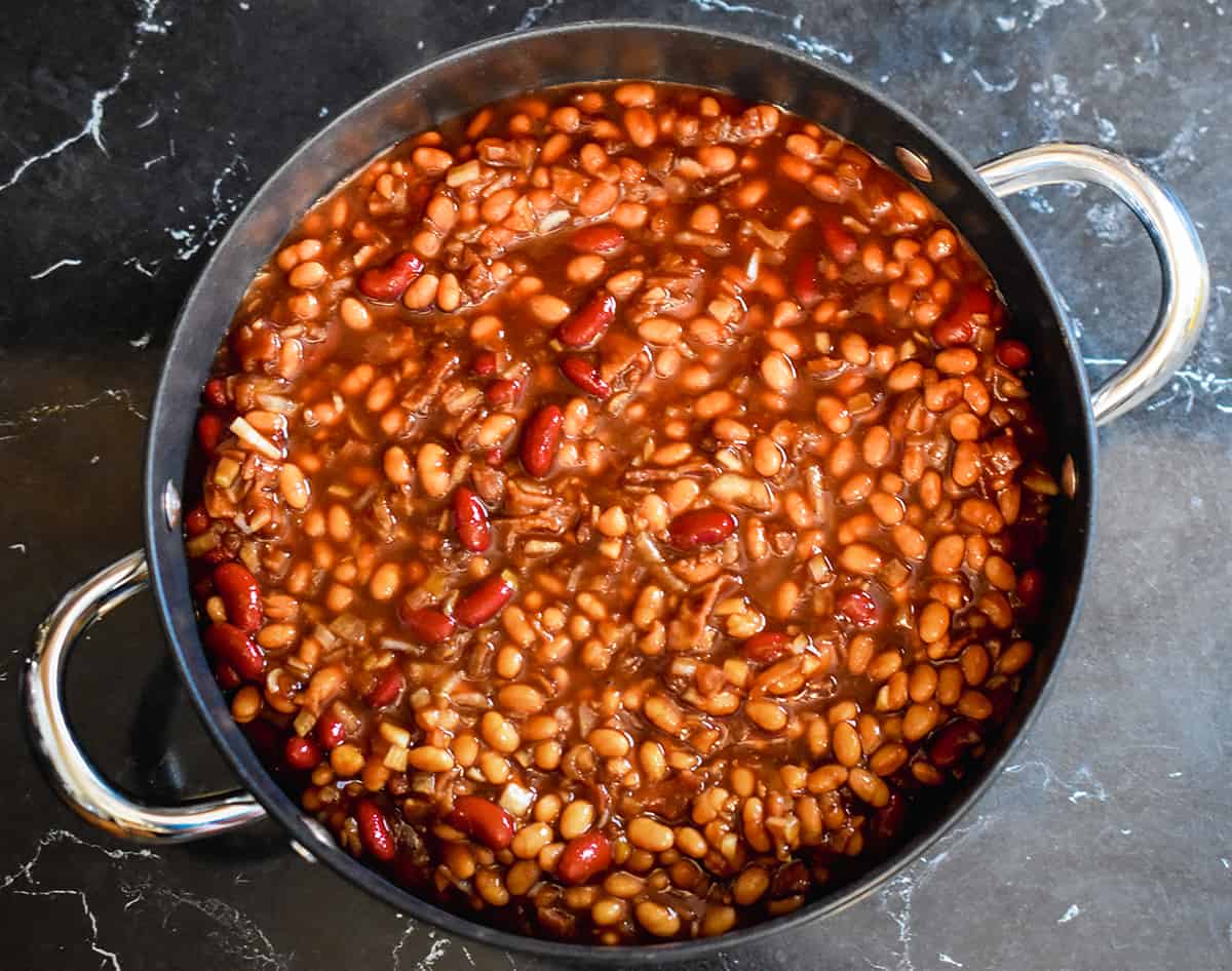 All of the ingredients for baked beans in a large pot.