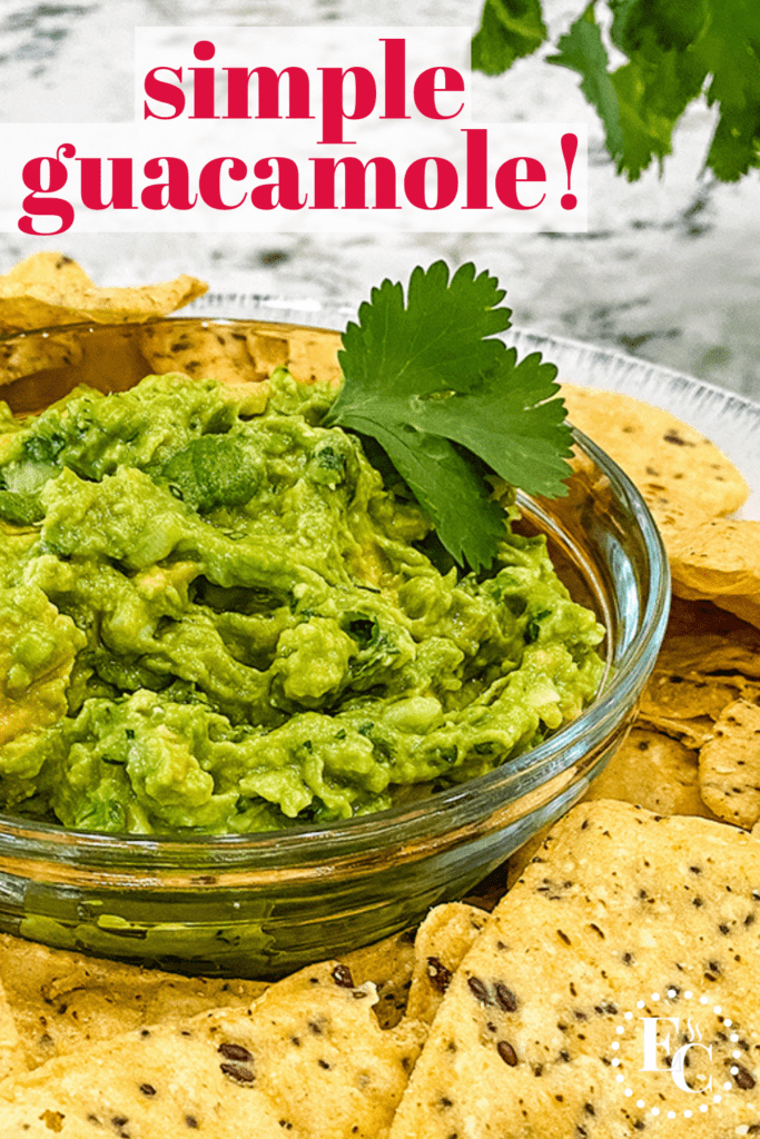 Bright green guacamole is in a clear glass bowl and surrounded with multi grain tortilla chips. Pinterest Pin #4.