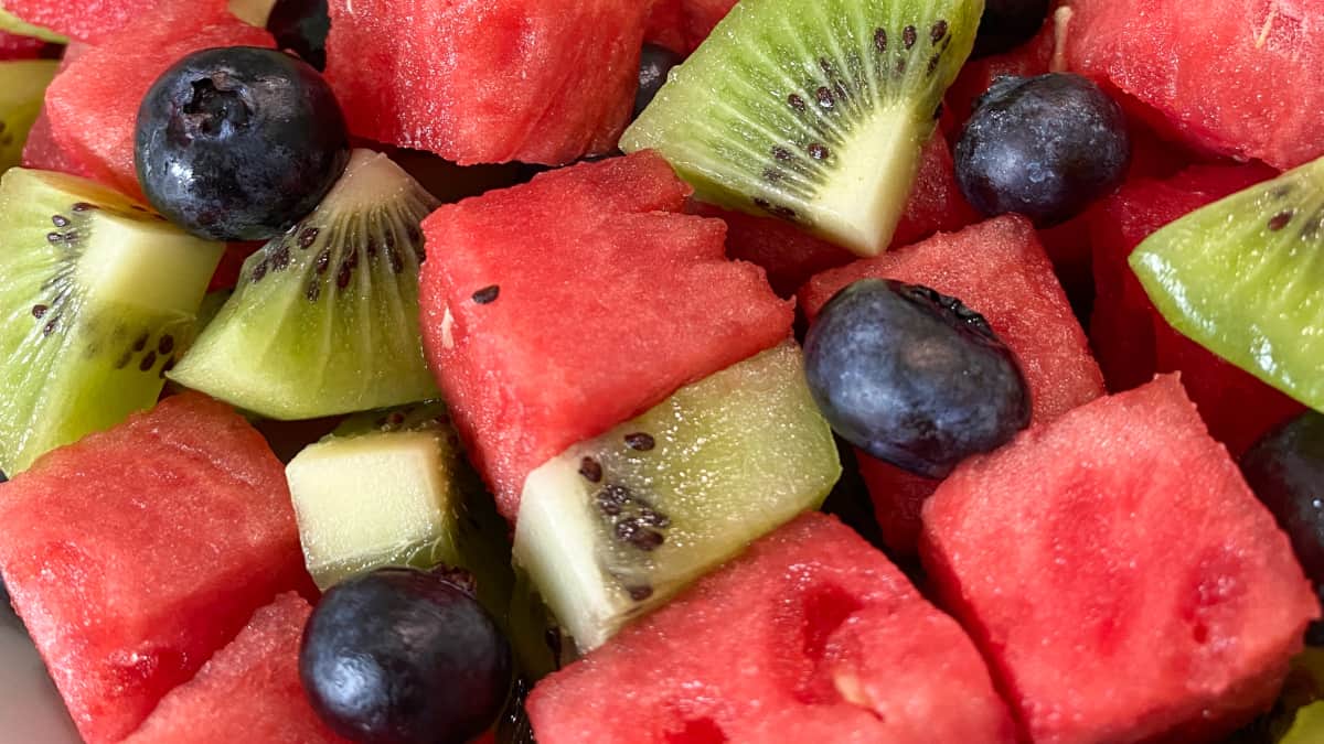 Close up view of the prepared fruit; cubes of watermelon, slices of kiwi, and blueberries.