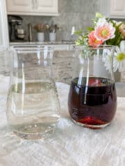 Square image of two carafes. One contains clear simple syrup and the other contains brown sugar simple syrup.