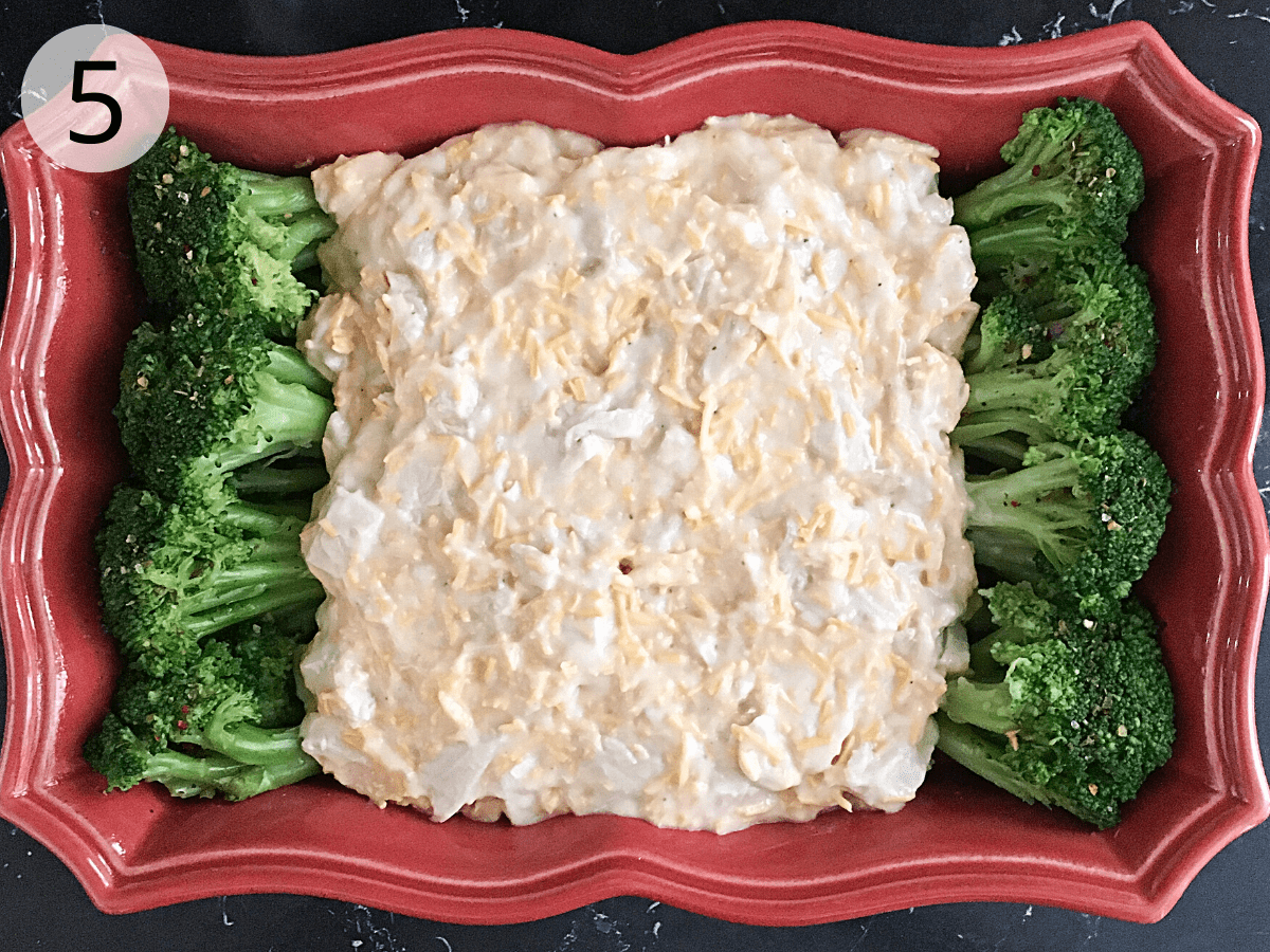 Leftover turkey with divan sauce is spooned over spears of broccoli in a casserole dish.