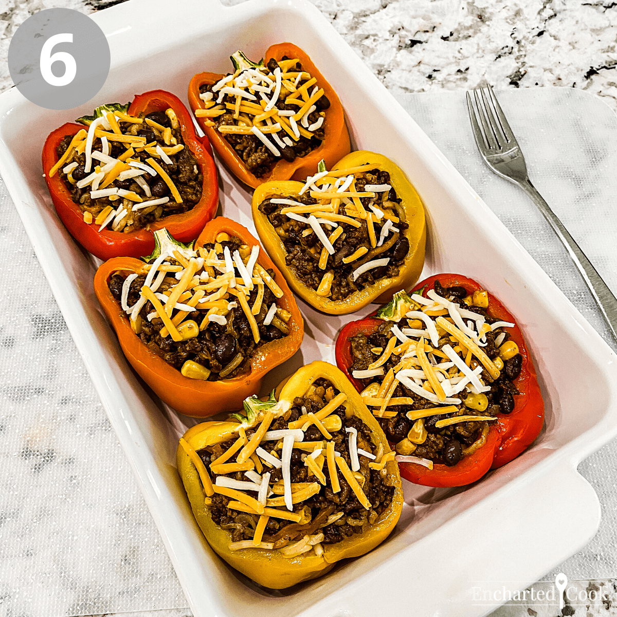 Halved bell peppers are filled with taco seasoned ground beef.