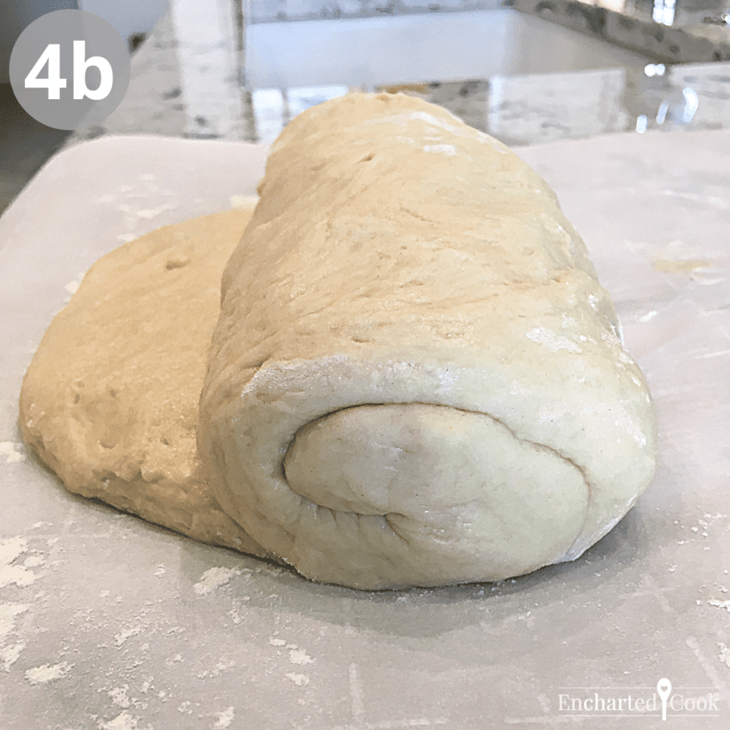 The dough is rolled up starting at the short end of the rectangle to shape the dough into a loaf.