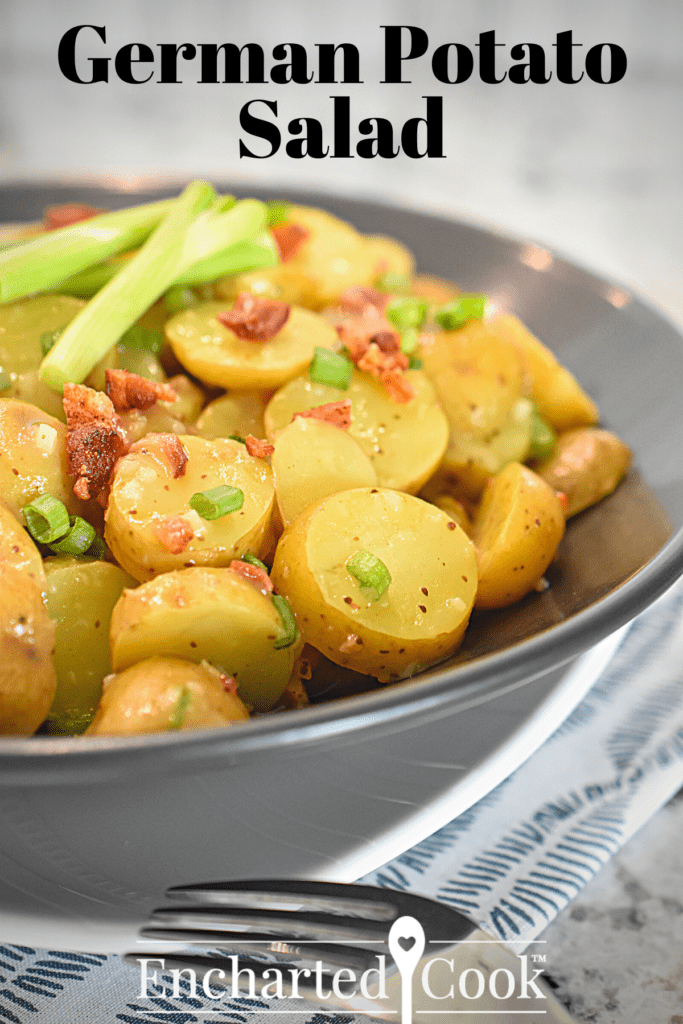 A salad of sliced potatoes, green onions, and bacon bits in a black bowl with a text overlay.
