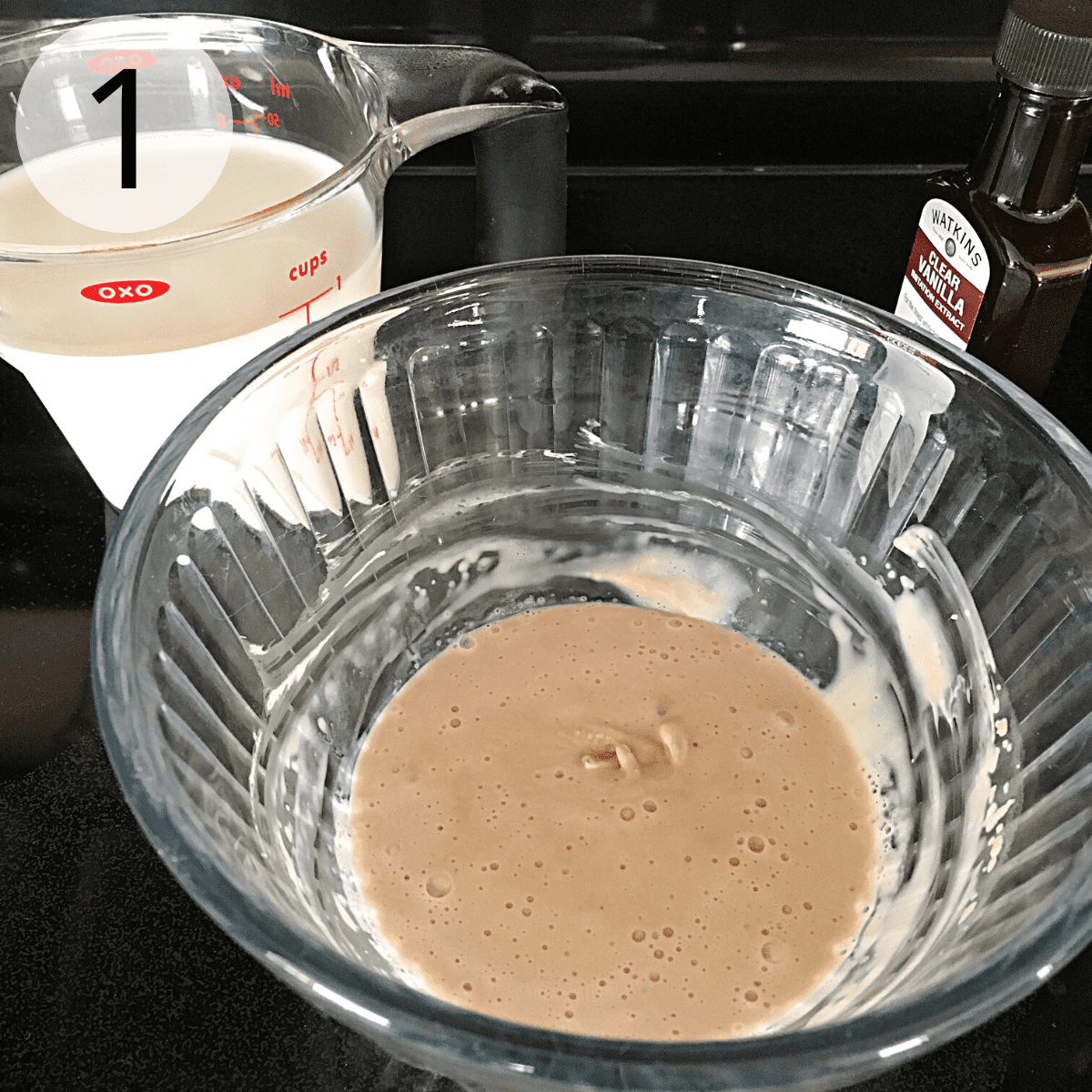 Mixing active dry yeast, sugar and water to proof the yeast.