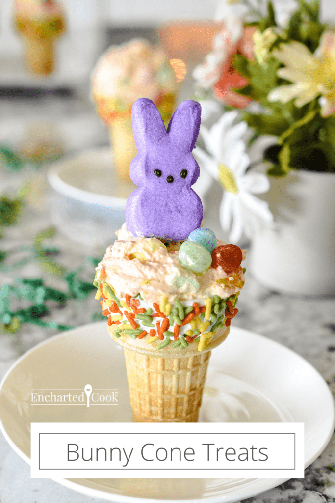 A decorated cake cone filled with orange fluff with a marshmallow bunny on top with text overlay.