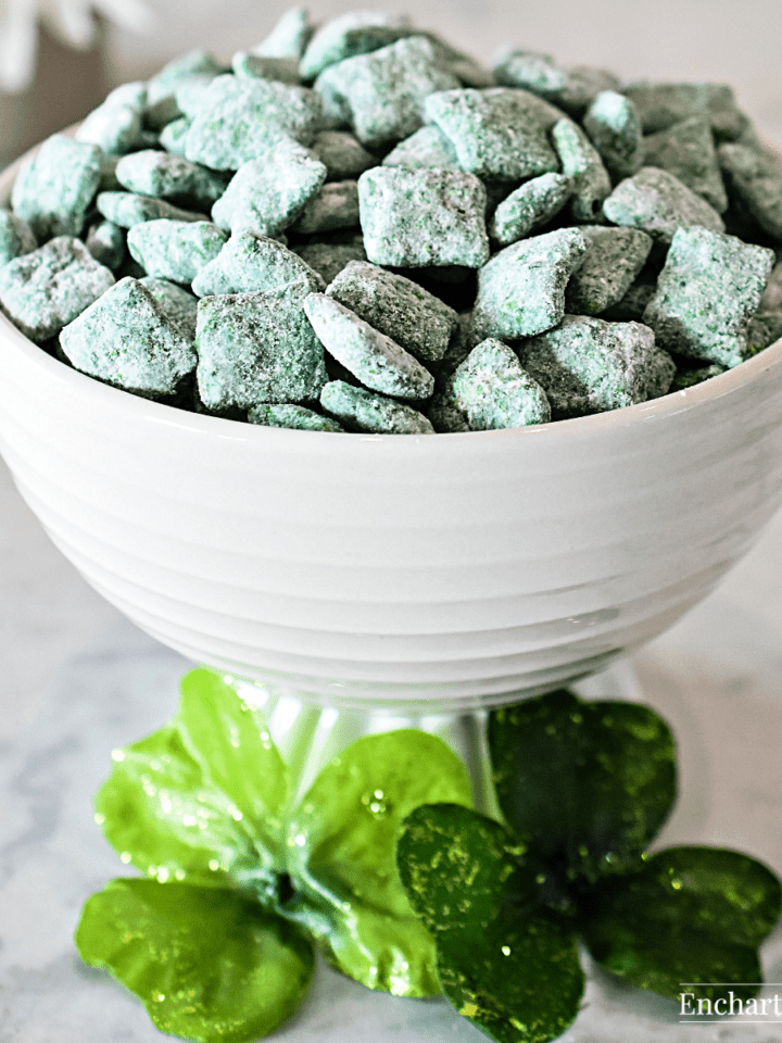 A white bowl with green party snack mix.