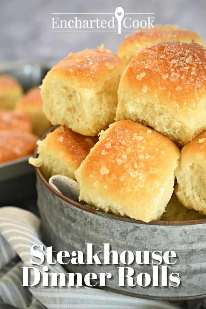 Dinner rolls piled into a rustic tin serving stand with text overlay.