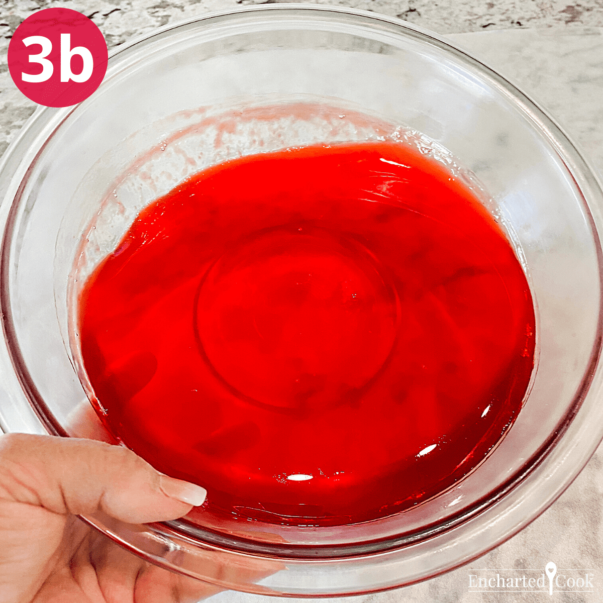 The Jell-O is slightly set when it clings to the edge of the bowl and slides away from the edge when the bowl is tipped.