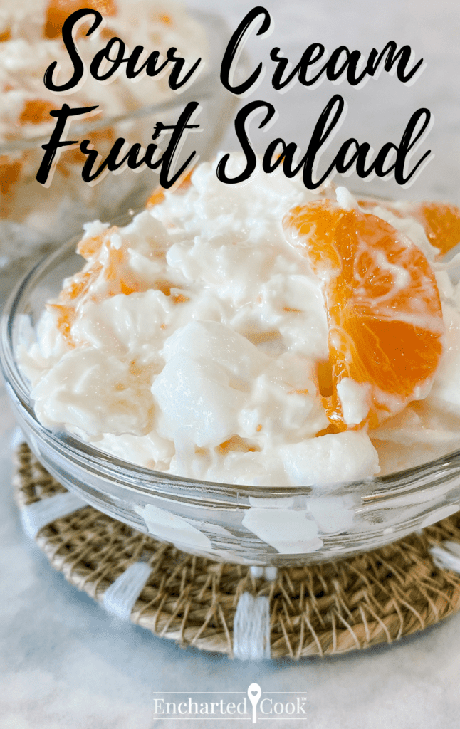 White and orange fruit salad in a small serving dish with script text overlay.