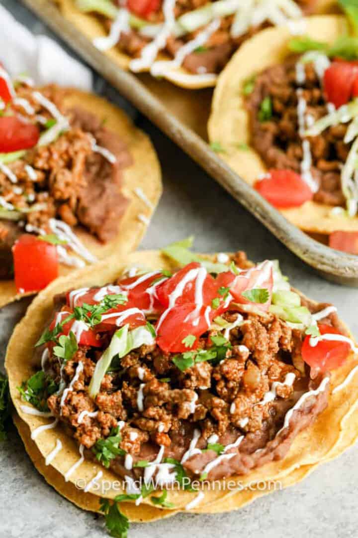 Ground beef, refried beans and toppings on a crisp tortilla.