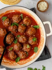 Ground beef meatballs in red adobo sauce.