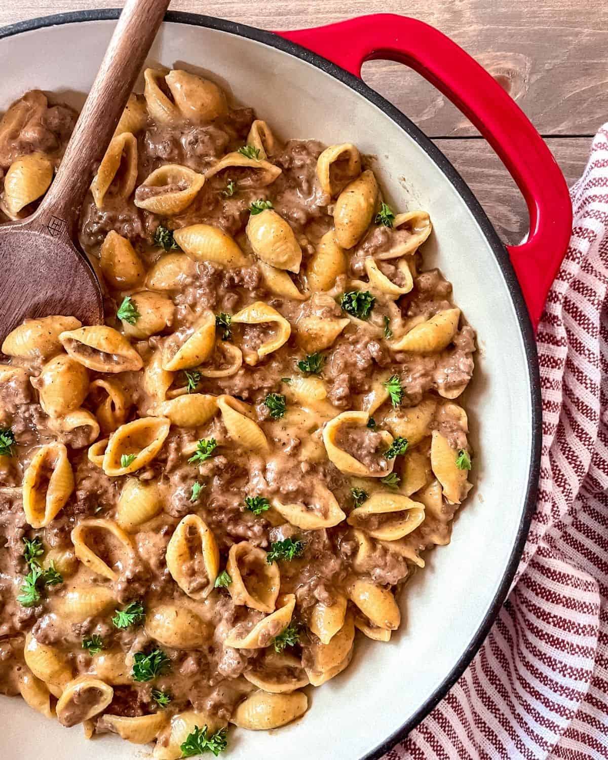 Ground beef and pasta shells in a brown creamy sauce.