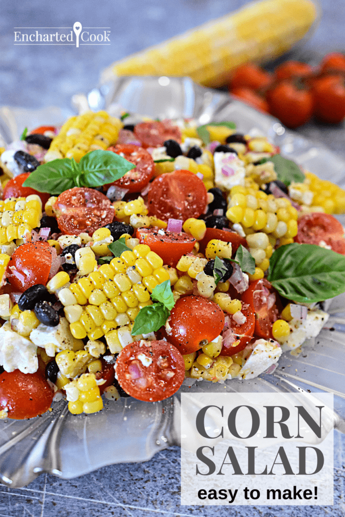 Corn Salad on a glass plate with an ear of corn and cherry tomatoes in the background with text overlay.