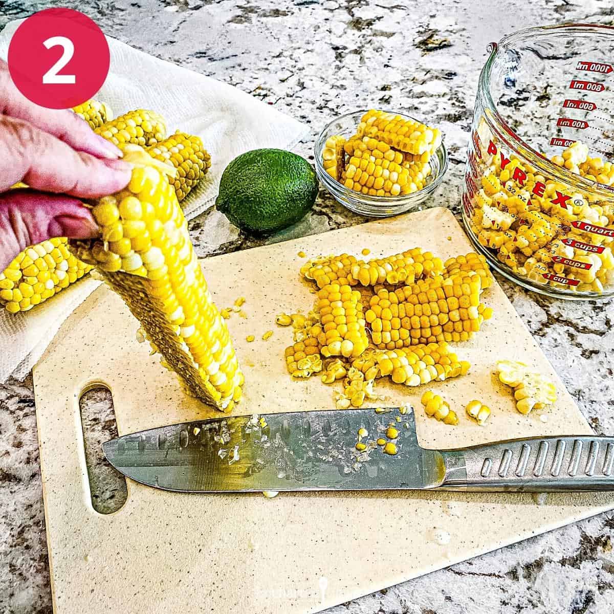 Cutting the kernels of corn from the cob.