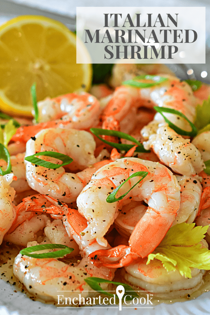 Vertical image of a plate of shrimp garnished with green onions, celery leaves, and a lemon half with text overlay.