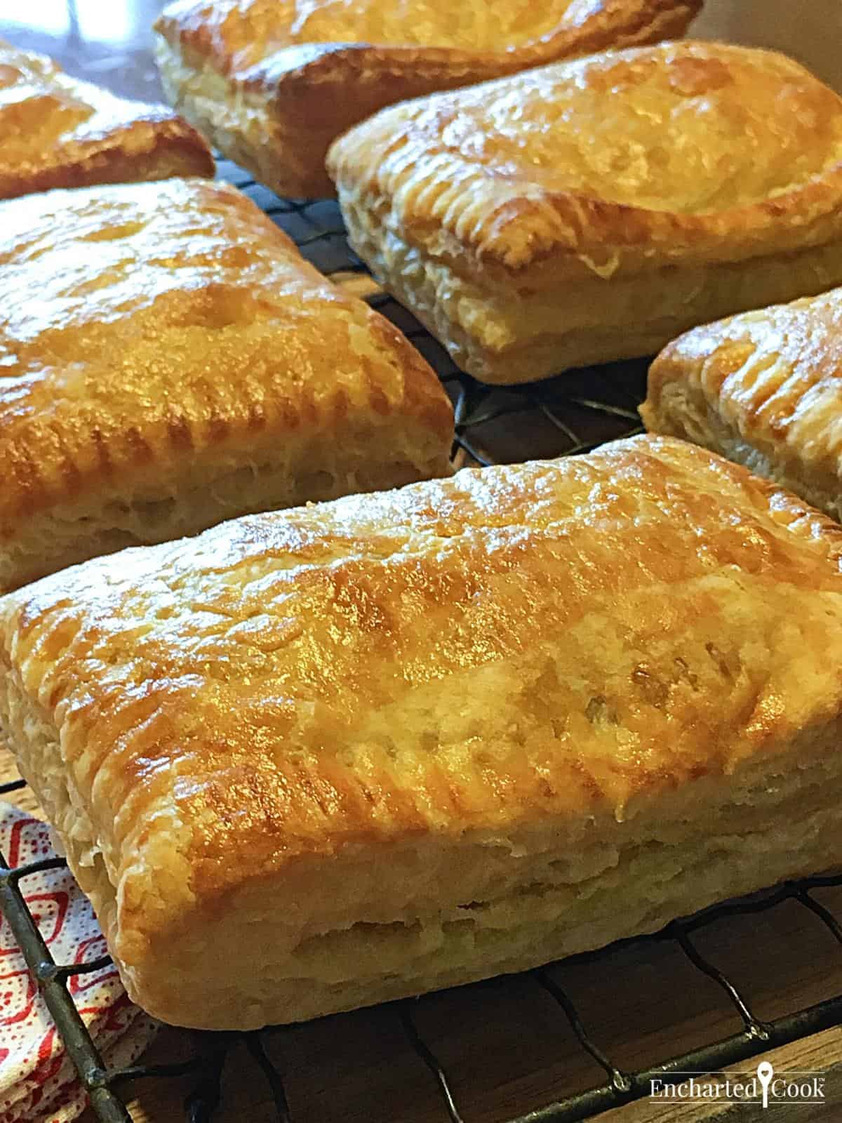 Rectangular puff pastry pocket pies on a wire cooling rack.
