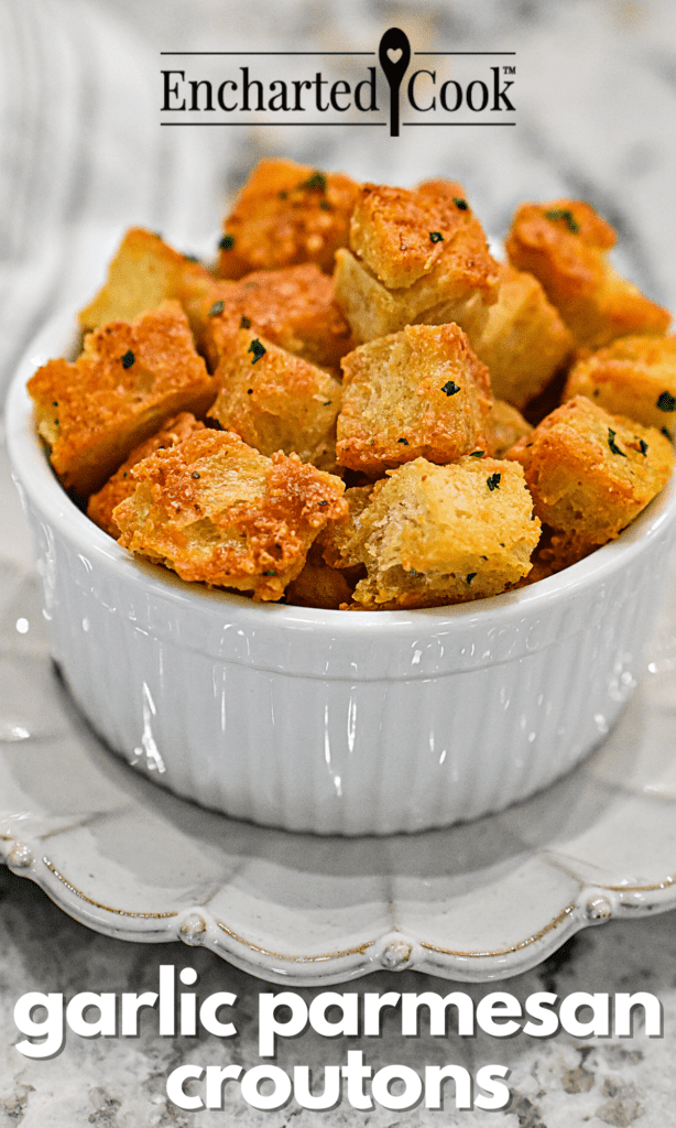 Garlic parmesan coated croutons in a white dish with text overlay.