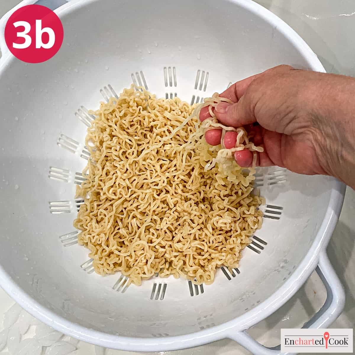 Process Photo 3b - Draining the cooled ramen noodles in a large colander.