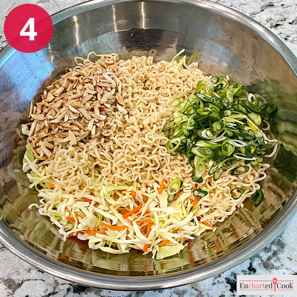 Process Photo 4 - The ramen, cole slaw mix, slivered almonds. and sliced green onions in a large bowl.