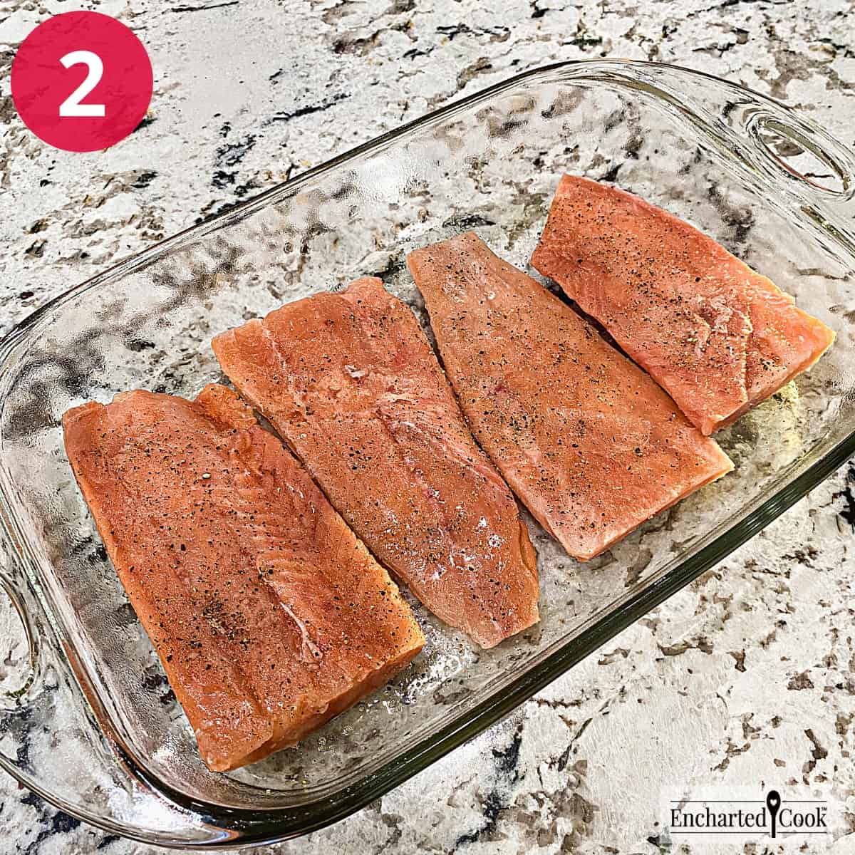 Process Photo 2 - The salmon is seasoned with salt and pepper in a baking dish.