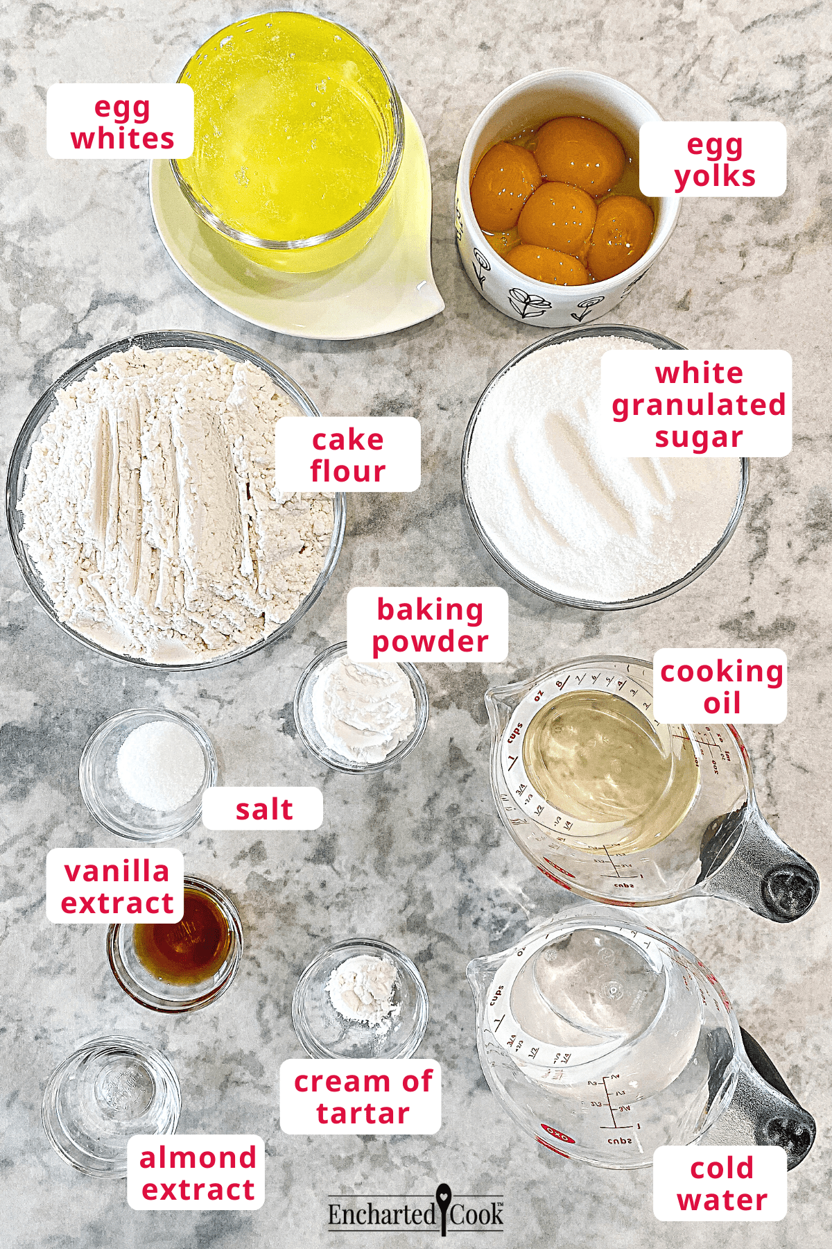 The cake ingredients, clockwise from top right: egg yolks, white granulated sugar, cooking oil, cold water, cream of tartar, almond extract, vanilla extract, salt, baking powder, cake flour, and egg whites.