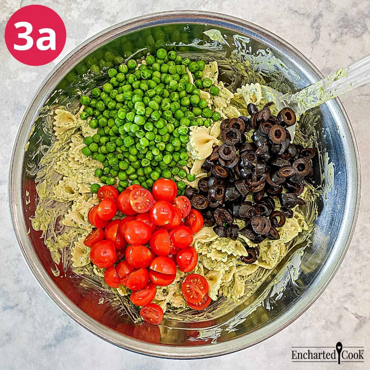 Process Photo 3a - Green peas, sliced black olives, and halved cherry tomatoes are added to the pasta and dressing.