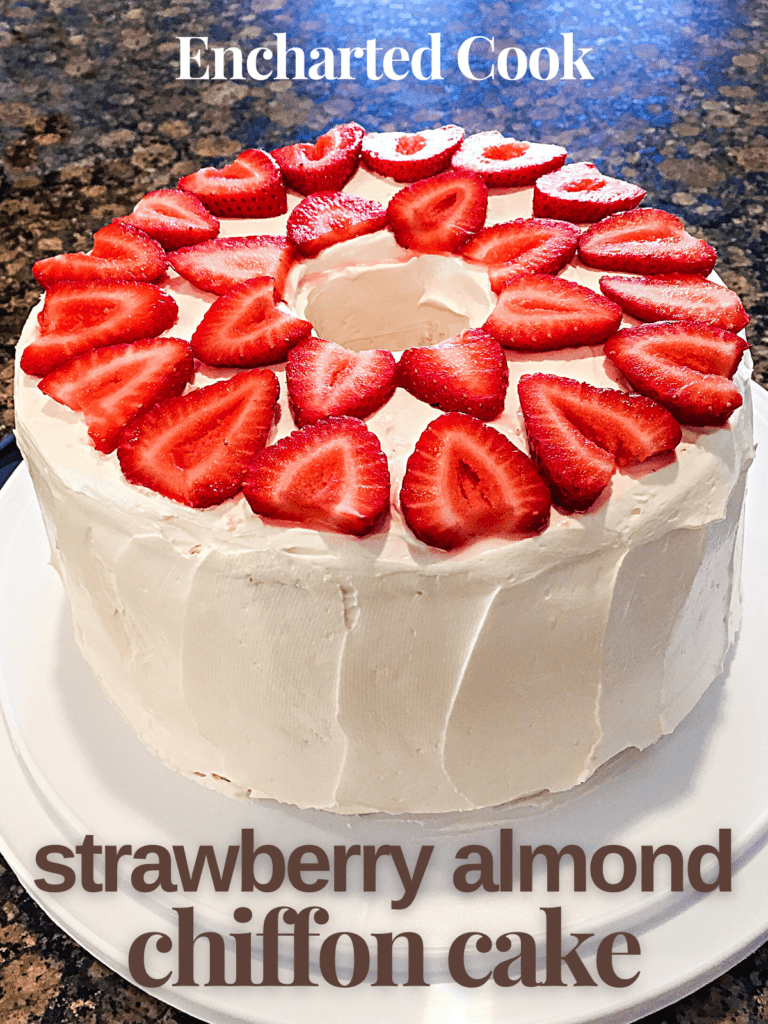 A tube cake in white frosting decorated with sliced strawberries on top with text overlay.
