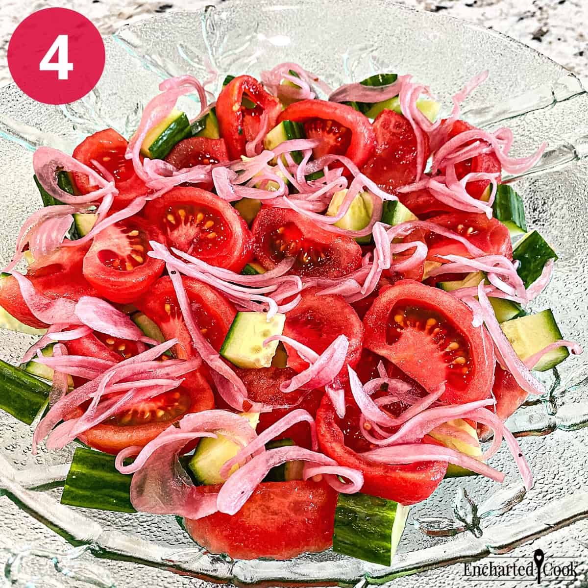 Process Photo 4 - Pickled red onion is added to the tomatoes and cucumbers in a large green glass bowl.