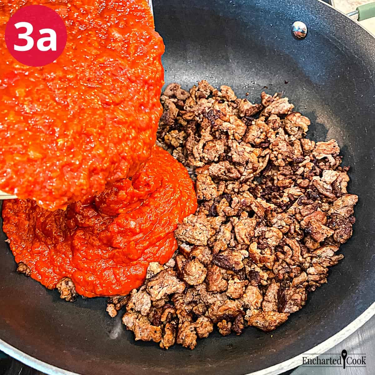 Process Photo 3a - Marinara sauce is added to browned ground beef in a large skillet.