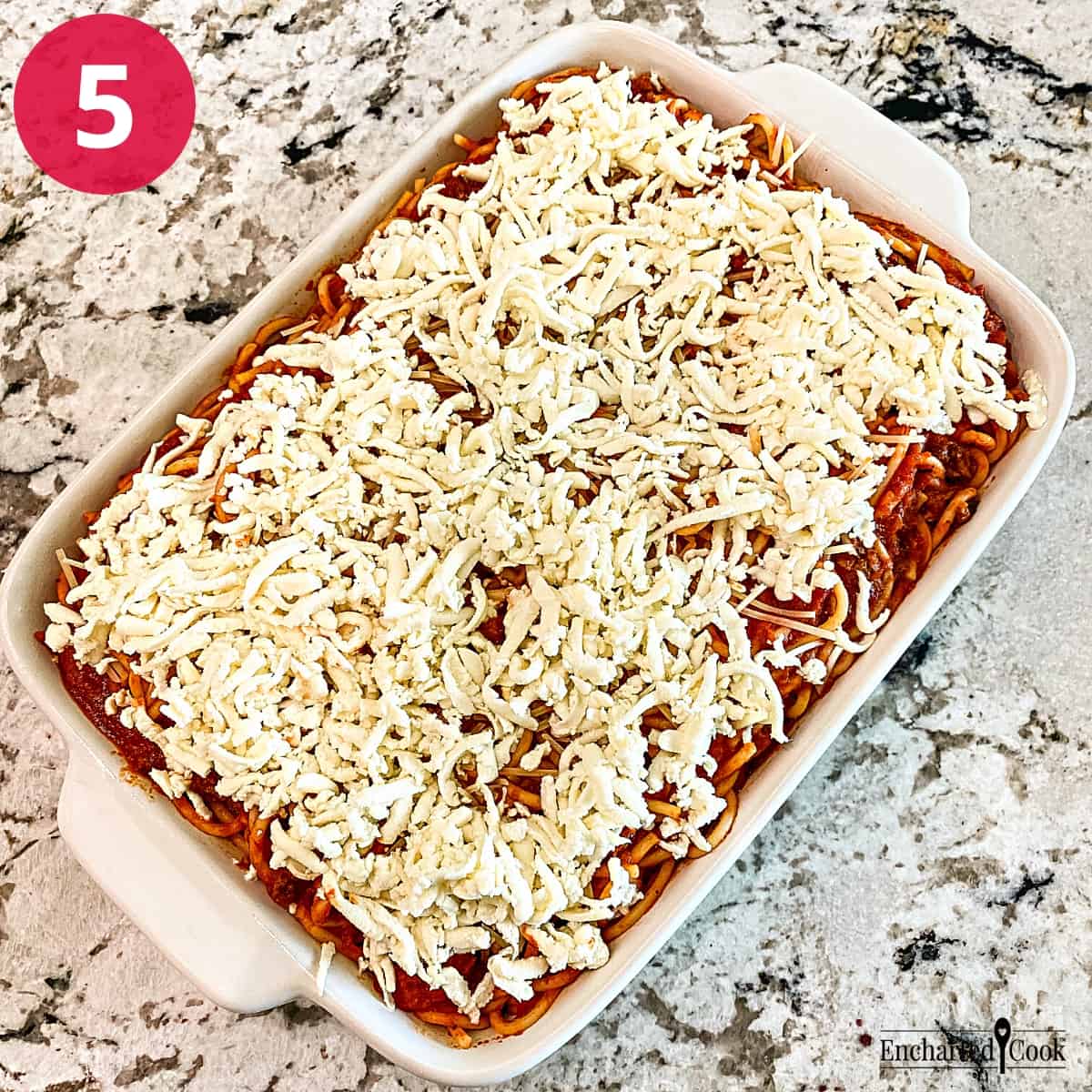 Process Photo 5 - Shredded mozzarella and parmesan cheese is sprinkled on top of the spaghetti casserole.