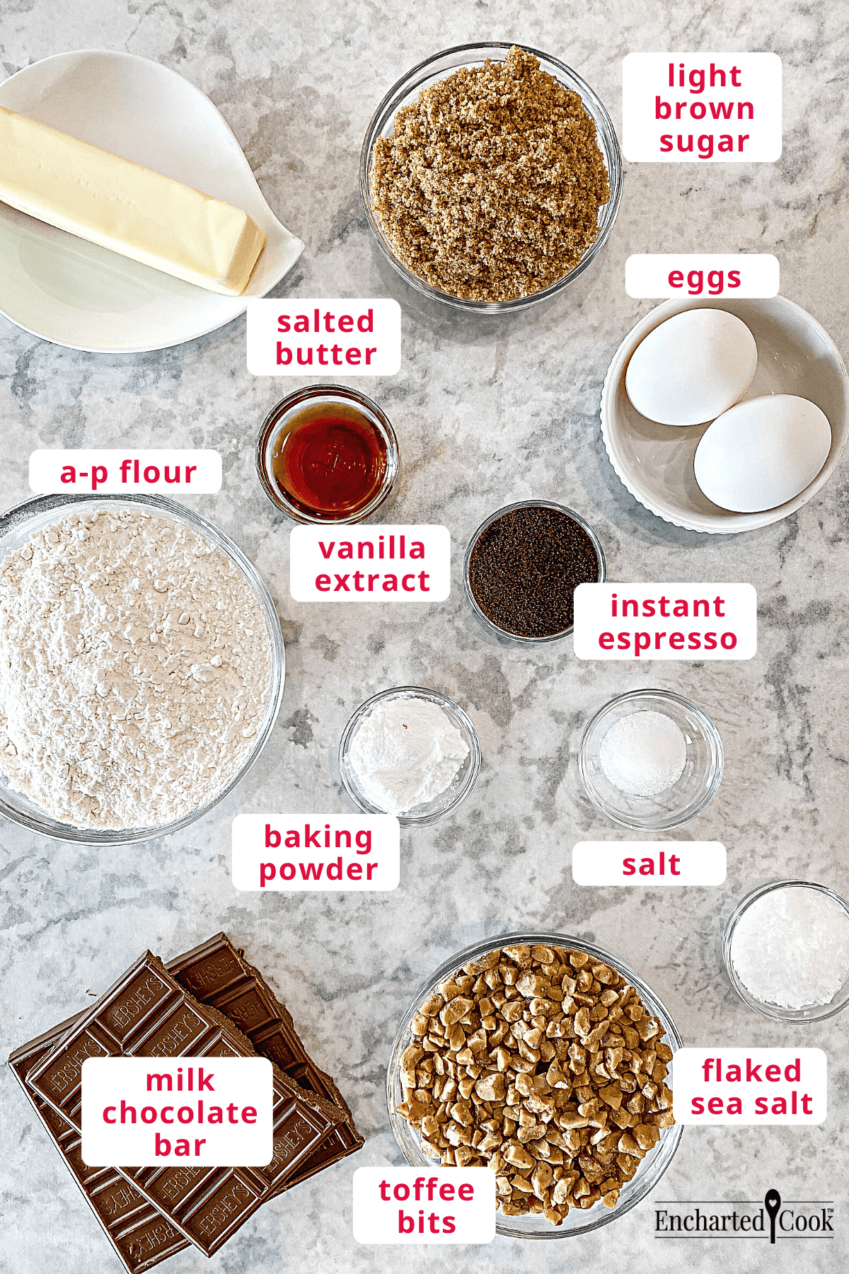 The ingredients, clockwise from top right: light brown sugar, eggs, instant espresso, salt, flaked sea salt, toffee bits, milk chocolate bar, baking powder, a-p flour, vanilla extract, and salted butter.