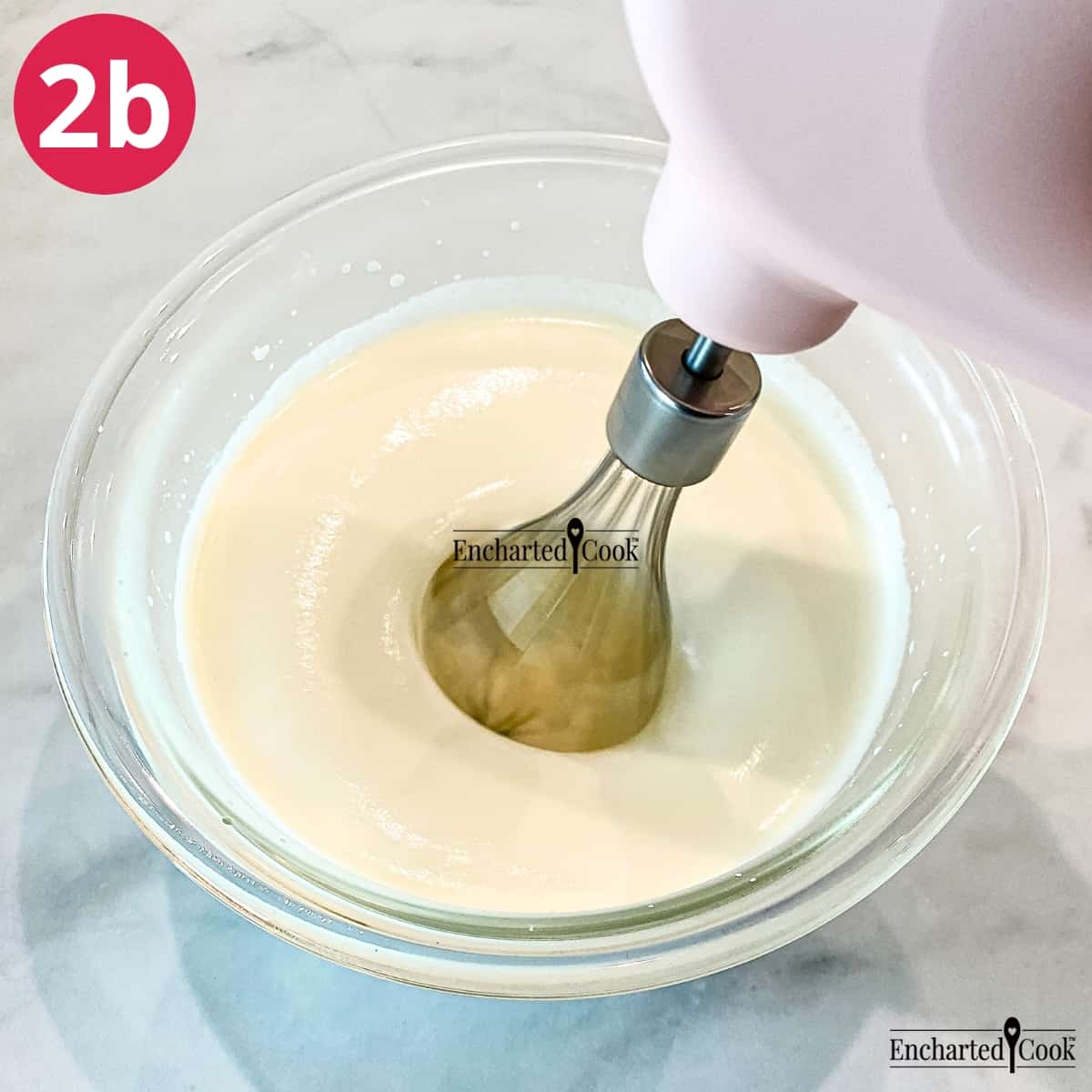 Process Photo 2b - Beating the cream, sugar, and vanilla in a deep glass bowl with a handheld mixer.