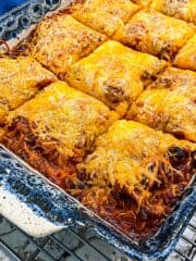 Lasagna with lots of melted cheese is cut into square servings and ready to serve.